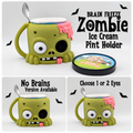 Green zombie ice cream pint holder with handle and spoon slot, shown with one-eye, two-eye, and no-brains designs