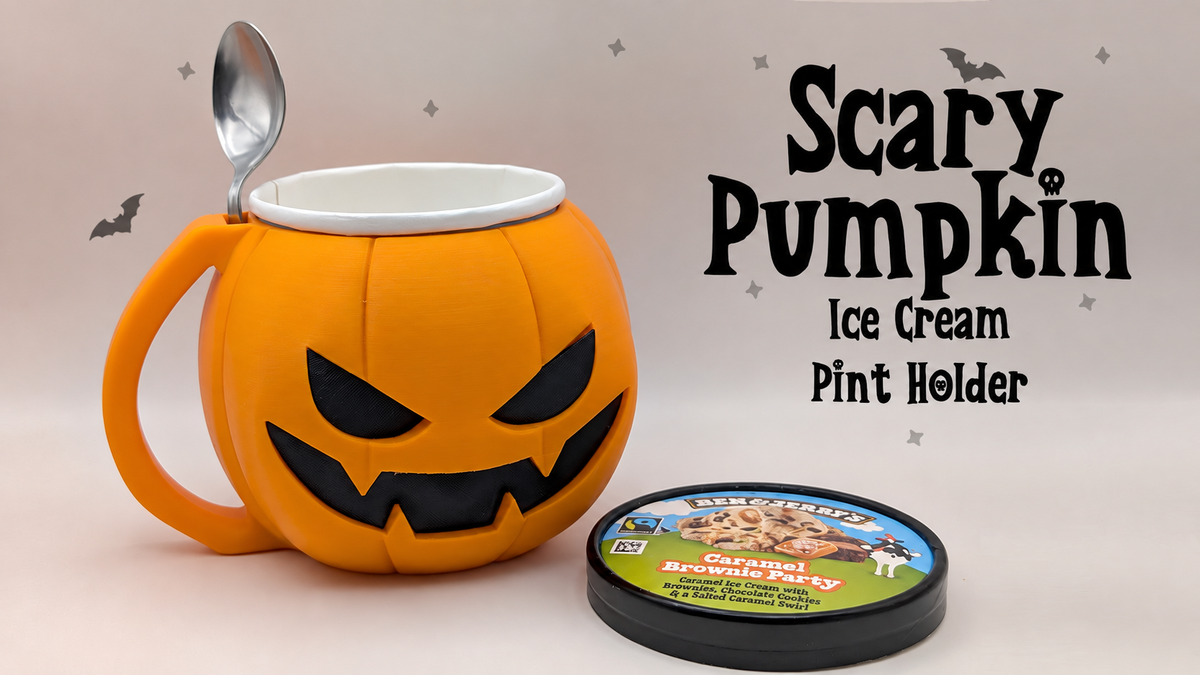 Orange jack-o'-lantern ice cream pint holder with black eyes and jagged smile, handle and spoon slot