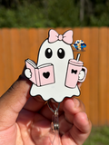 White ghost badge reel with a pink bow holding a pink book and drink cup