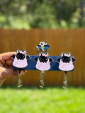 Black bat badge reels with pink bows and pale pink wraps on retractable clips