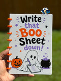 Open Halloween notebook showing lined pages and orange disc-style binding