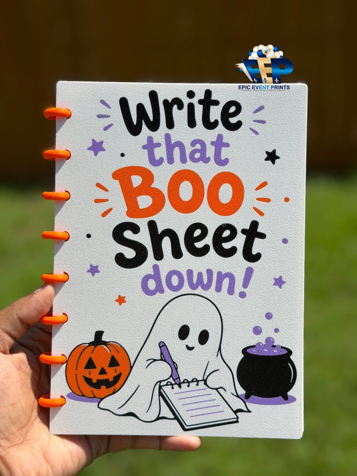Open Halloween notebook showing lined pages and orange disc-style binding