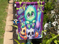 Orange one-eyed monster beside Spooky Halloween sign and jack-o'-lantern on garden flag