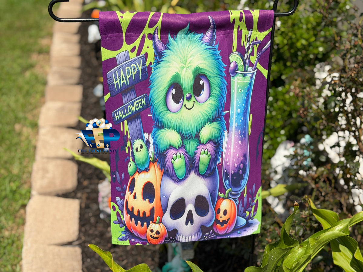 Orange one-eyed monster beside Spooky Halloween sign and jack-o'-lantern on garden flag